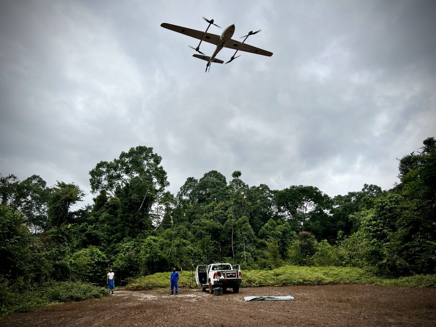 VTOL aircraft climbing away from the hangar