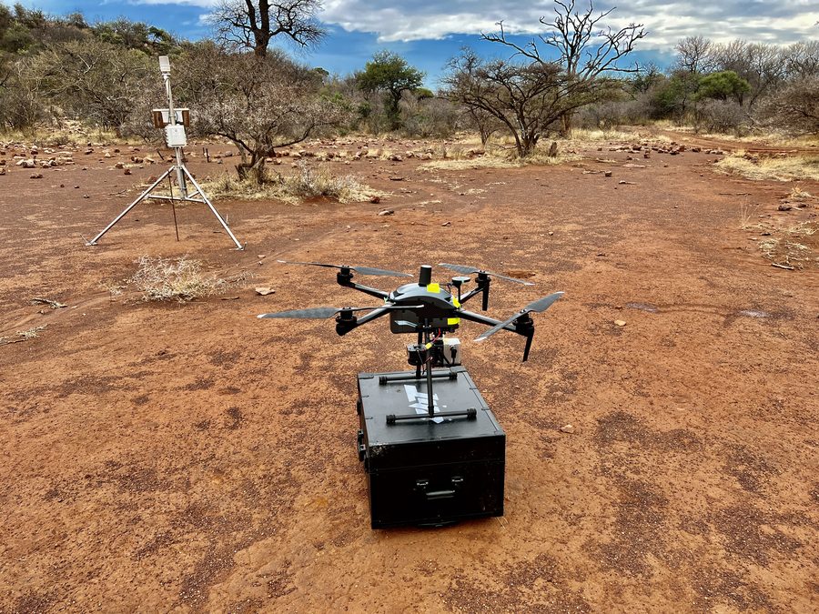 Multirotor LiDAR aircraft on its transit case on red soil